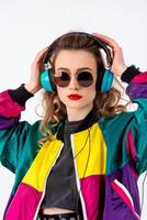 A woman wearing sunglasses and a colorful jacket with headphones photo