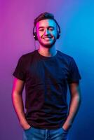 A man in a black t - shirt and headphones photo