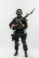 A man in military gear holding a rifle photo