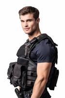 A man in a vest and pants holding a gun photo