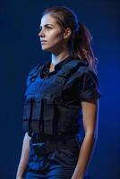 A woman in a police uniform standing against a blue background photo