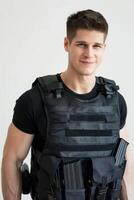A man in a black vest with a gun photo