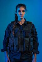 A woman in a police uniform standing against a blue background photo