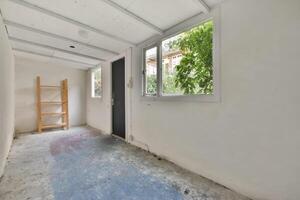 A room with a ladder and a window photo
