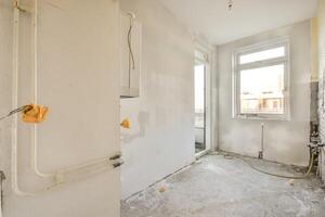 A room with a window and a toilet in it photo