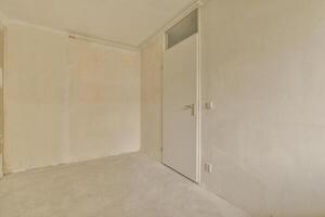 A room with a white door and a white floor photo