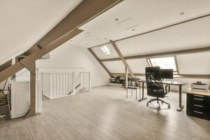 An office with a desk and chair in an attic photo