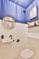 A bathroom with a toilet, sink, and mirror photo