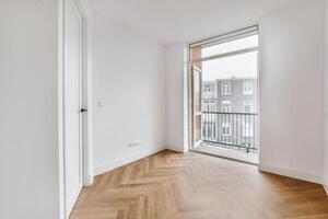 A room with white walls and wooden floors photo