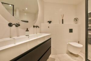 A bathroom with a toilet, sink, and shower photo