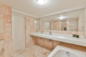 A bathroom with a sink and a mirror photo
