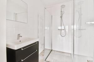 A bathroom with a sink and a shower stall photo