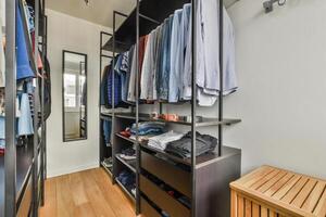 A walk - in closet with a wooden floor and a wooden shelf photo