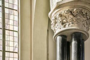A tall column with a window in front of it photo