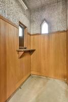 An empty room with a wooden wall and a window photo