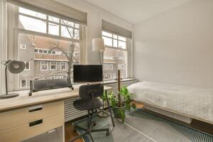 A bedroom with a desk and a bed photo