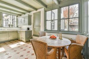 A kitchen with a table and chairs in it photo