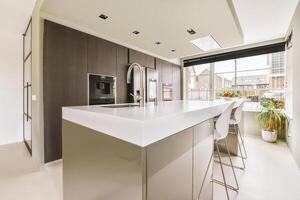 A kitchen with a large island and a window photo