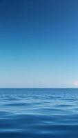 Calm Ocean Surface Reflecting a Clear Open Sky photo