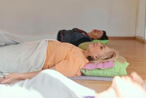 Senior woman practicing stretching and meditation on the floor, focusing on proper alignment and relaxation. photo