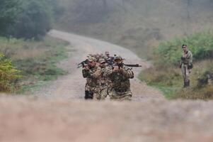 A disciplined and specialized military unit, donned in camouflage, strategically patrolling and maintaining control in a high-stakes environment, showcasing their precision, unity, and readiness for photo