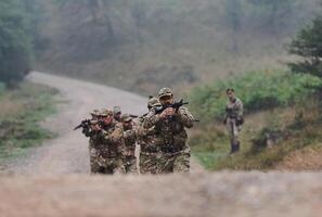 A disciplined and specialized military unit, donned in camouflage, strategically patrolling and maintaining control in a high-stakes environment, showcasing their precision, unity, and readiness for photo