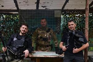Two videographers collaborate seamlessly, capturing moments with a military major at his base, illustrating a harmonious blend of technology, media, and military communication in the production of a photo