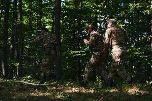A specialized military antiterrorist unit conducts a covert operation in dense, hazardous woodland, demonstrating precision, discipline, and strategic readiness photo