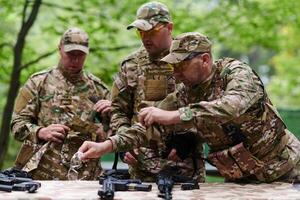 An elite military unit prepares for a hazardous forest operation, showcasing tactical prowess, camouflage skills, and strategic readiness photo