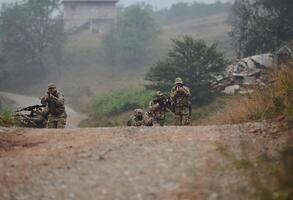 A disciplined and specialized military unit, donned in camouflage, strategically patrolling and maintaining control in a high-stakes environment, showcasing their precision, unity, and readiness for photo
