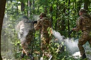 A specialized military antiterrorist unit conducts a covert operation in dense, hazardous woodland, demonstrating precision, discipline, and strategic readiness photo