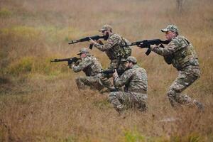A disciplined and specialized military unit, donned in camouflage, strategically patrolling and maintaining control in a high-stakes environment, showcasing their precision, unity, and readiness for photo