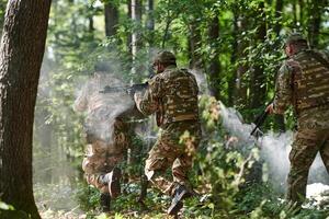 A specialized military antiterrorist unit conducts a covert operation in dense, hazardous woodland, demonstrating precision, discipline, and strategic readiness photo