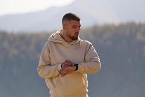 Athletic man maintains his healthy lifestyle by running through the scenic mountain and lakeside environment, showcasing a commitment to fitness and well-being photo