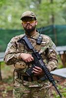 Elite soldier exudes focused determination and readiness, geared up for a perilous military operation, capturing the essence of courage and professionalism in the face of imminent danger photo