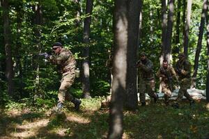 A specialized military antiterrorist unit conducts a covert operation in dense, hazardous woodland, demonstrating precision, discipline, and strategic readiness photo