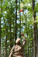 Elite military unit, equipped with state-of-the-art technology including a drone, strategically navigates and surveys dangerous wooded terrain, showcasing their precision, cooperation, and specialized photo