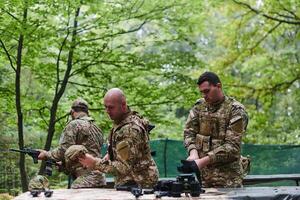 An elite military unit prepares for a hazardous forest operation, showcasing tactical prowess, camouflage skills, and strategic readiness photo