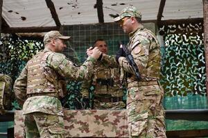 A highly trained military unit strategizes and organizes a tactical mission while studying a military map during a briefing session photo
