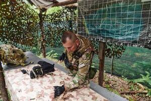 The esteemed leader of an elite military unit, strategic brilliance unfolds as he meticulously devises tactical plans for the upcoming military operation, surrounded by cutting-edge technology and a photo