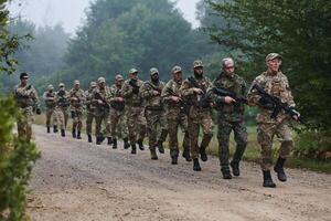 An elite military unit, led by a major, confidently parades through dense forest, showcasing precision, discipline, and readiness for high-risk operations photo