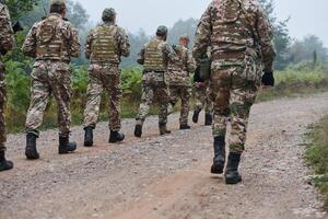 An elite military unit, led by a major, confidently parades through dense forest, showcasing precision, discipline, and readiness for high-risk operations photo