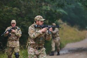 A disciplined and specialized military unit, donned in camouflage, strategically patrolling and maintaining control in a high-stakes environment, showcasing their precision, unity, and readiness for photo