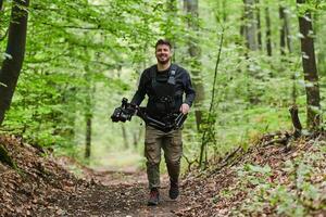 A videographer captures the intensity of a perilous military operation, documenting soldiers in action amidst the dense forest, showcasing the hazardous conditions and tactical maneuvers undertaken by photo