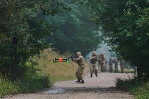 Elite military unit parading and securing the forest, utilizing drones for terrain scanning and reconnaissance, showcasing their advanced skills and specialized training in high risk operations photo