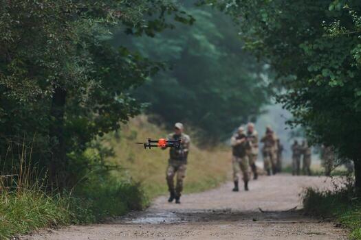 Elite military unit parading and securing the forest, utilizing drones for terrain scanning and reconnaissance, showcasing their advanced skills and specialized training in high risk operations photo