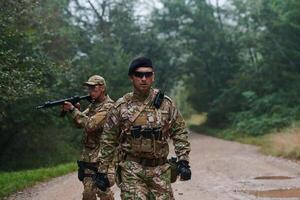 A disciplined and specialized military unit, donned in camouflage, strategically patrolling and maintaining control in a high-stakes environment, showcasing their precision, unity, and readiness for photo