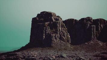 A large rock formation in the middle of a desert video