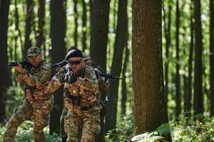 A specialized military antiterrorist unit conducts a covert operation in dense, hazardous woodland, demonstrating precision, discipline, and strategic readiness photo