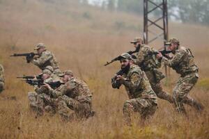 A disciplined and specialized military unit, donned in camouflage, strategically patrolling and maintaining control in a high-stakes environment, showcasing their precision, unity, and readiness for photo